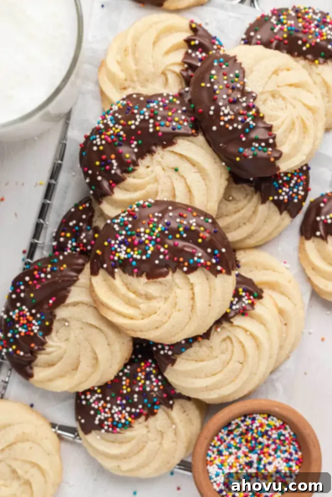 Golden Butter Delights 2 An overhead view of a pile of homemade butter cookies dipped in chocolate.