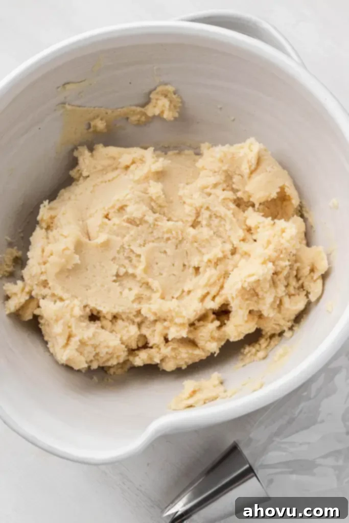 Golden Butter Delights 4 An overhead view of butter cookie dough in a white mixing bowl.