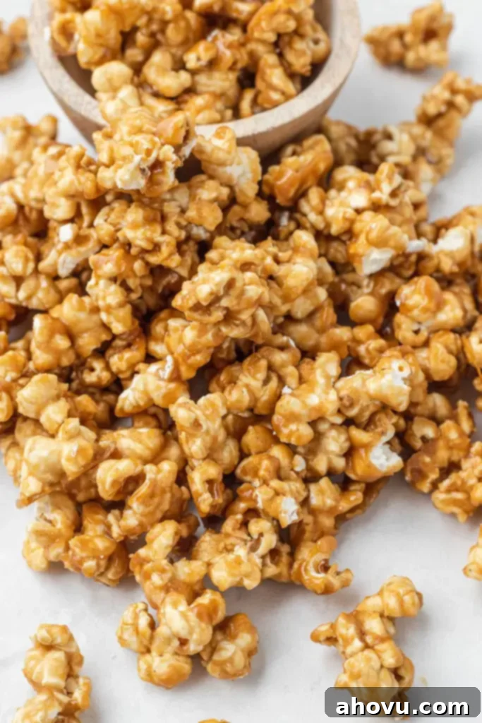 A mound of homemade caramel popcorn next to a small dish of it. 
