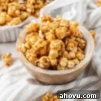A small wooden bowl filled with caramel corn.
