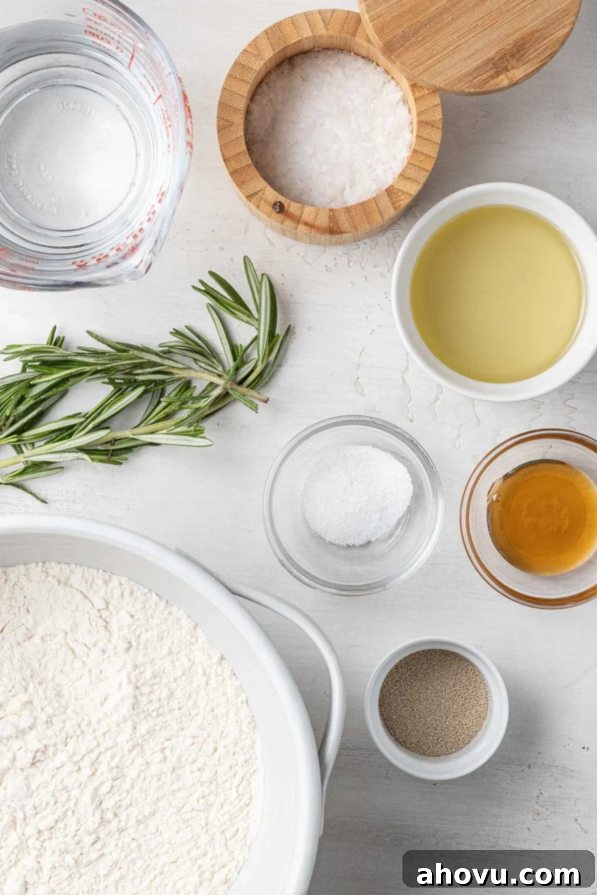 An overhead view of the ingredients needed to make focaccia bread with rosemary. 