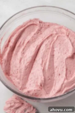 An overhead view of a glass mixing bowl of pound cake batter.