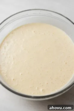 Sponge cake batter in a glass mixing bowl.