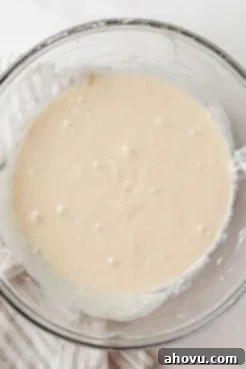 Overhead view of unproofed monkey bread dough in a glass mixing bowl.