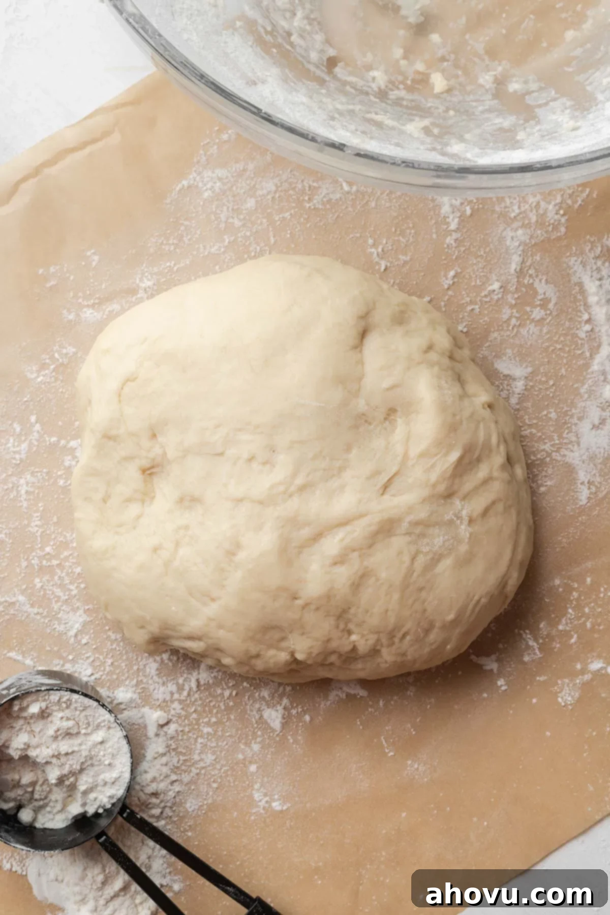 A ball of homemade dough on parchment paper.
