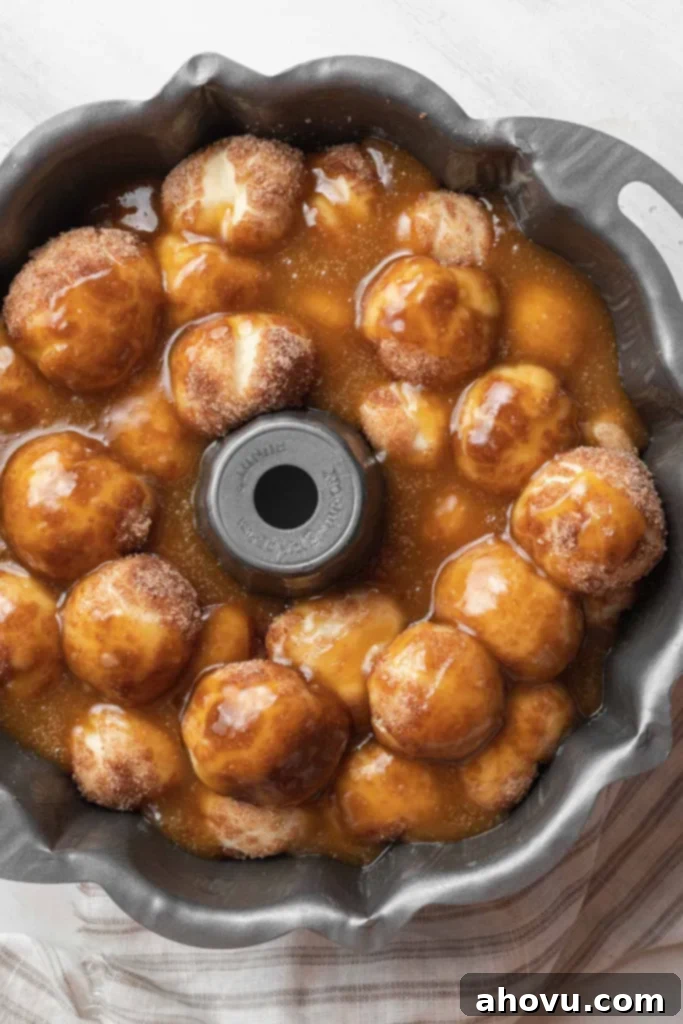 An overhead view of an assembled but unbaked pan of homemade monkey bread. 
