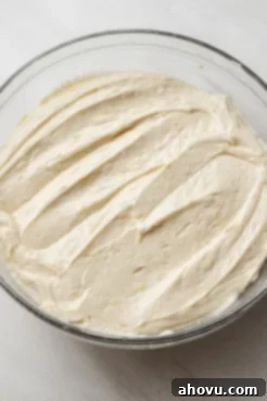 Lemon pound cake batter in a glass mixing bowl.