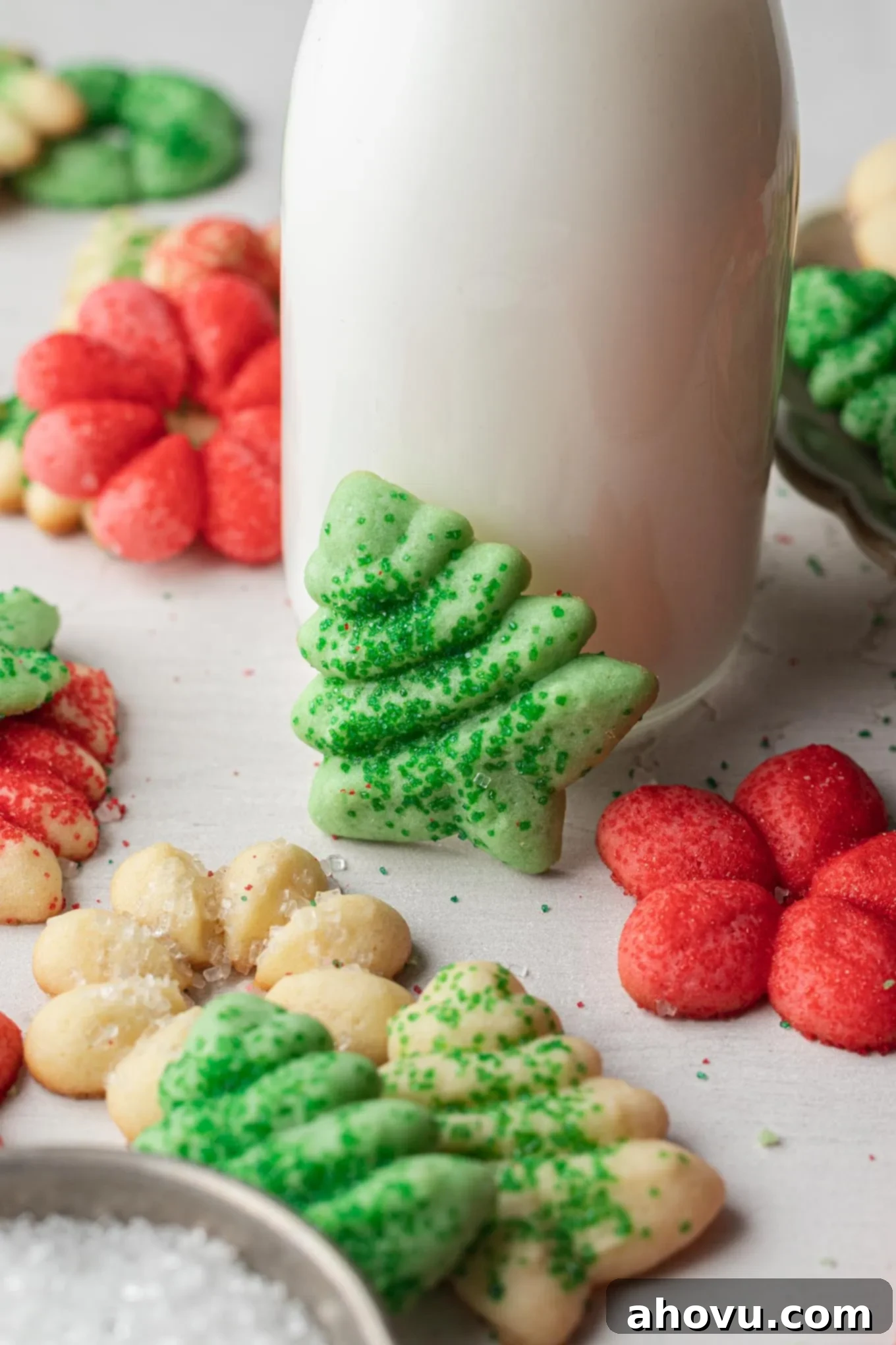 A jug of milk surrounded by classic spritz cookies. 