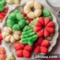 A pile of spritz cookies on a small plate.