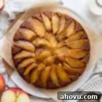 An overhead shot of caramel apple upside-down cake with apples and milk around it, showcasing its delicious appeal.