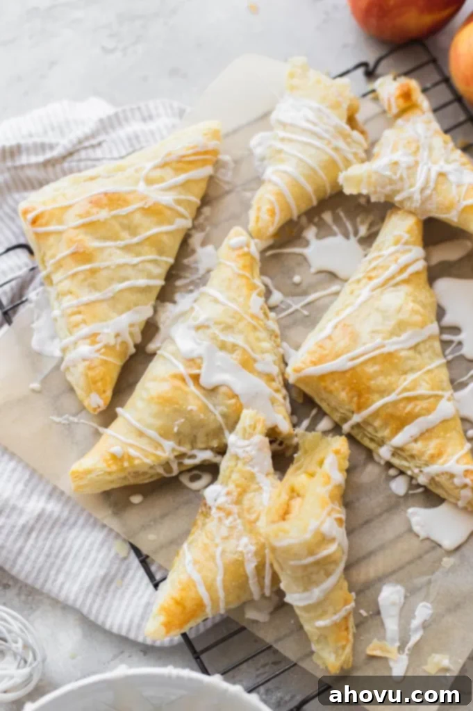 Flaky Apple Delights 4 A batch of turnovers arranged on a cooling rack and topped with a maple cinnamon glaze.