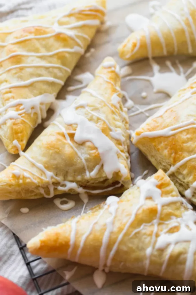 Flaky Apple Delights 5 An up close image of apple turnovers topped with a maple cinnamon glaze.