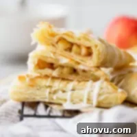 Flaky Apple Delights 6 A stack of apple turnovers with one cut in half showing the apple filling.