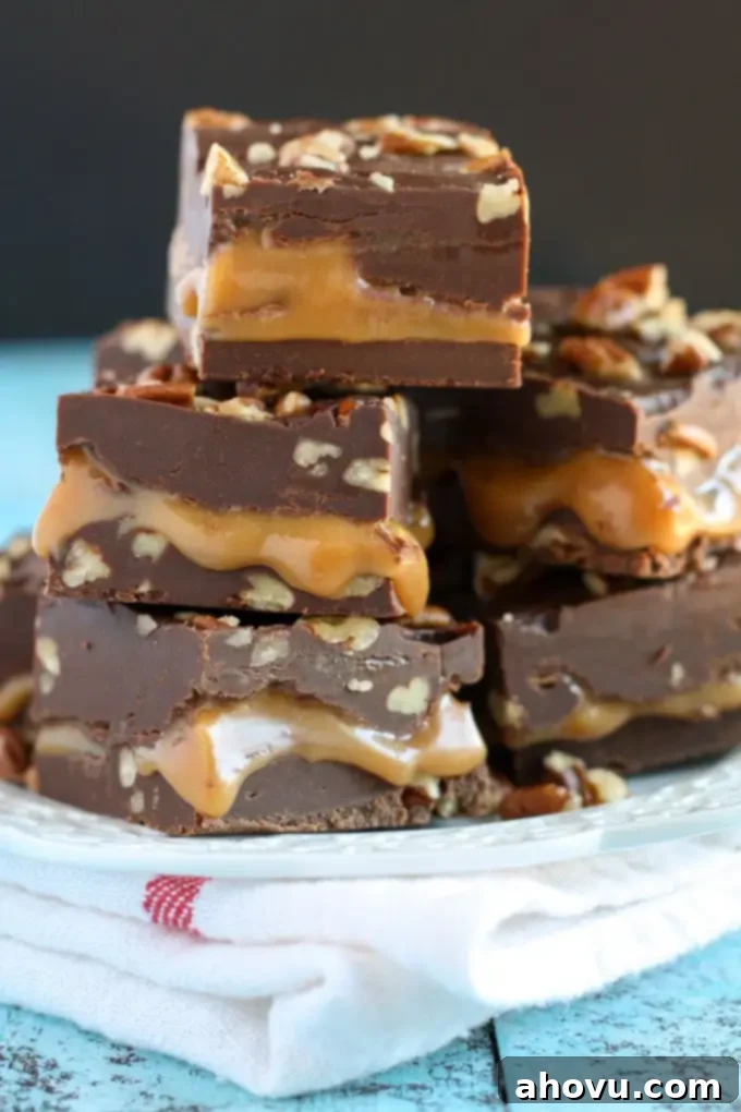 Close-up of a square of Turtle Fudge, showing the distinct layers of chocolate, caramel, and pecans.