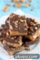 A small stack of homemade Turtle Fudge squares with a gooey caramel center.
