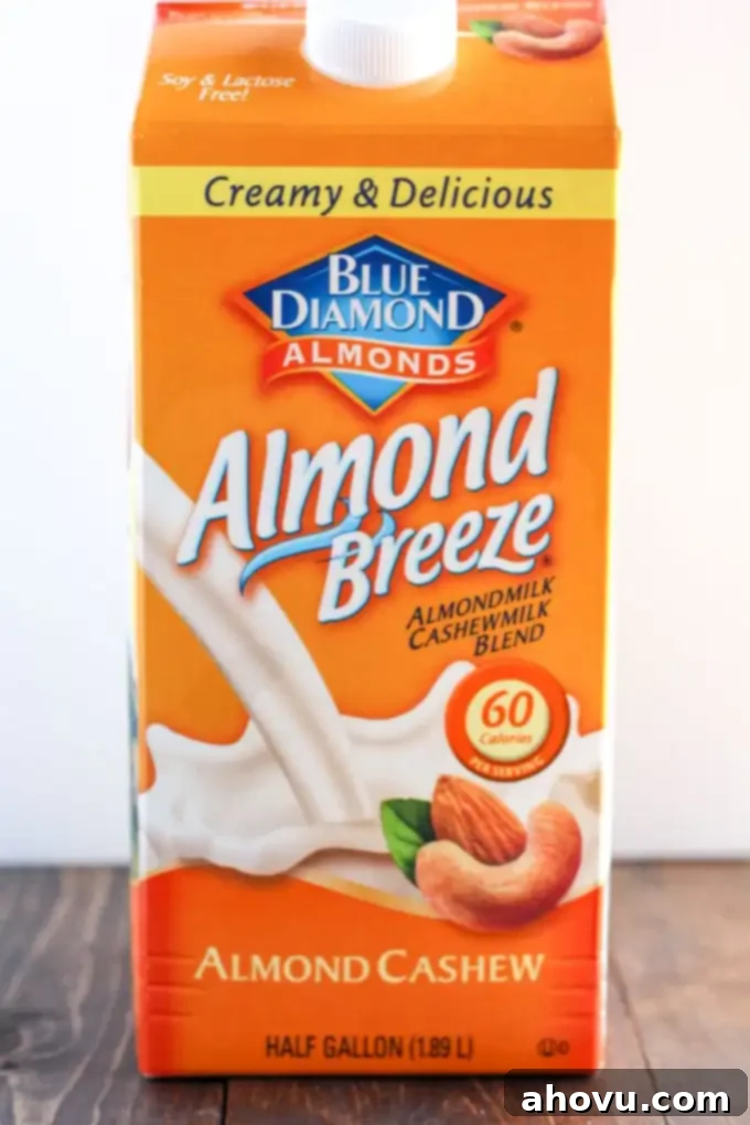 Cozy Gingerbread Flapjacks 4 A bright blue carton of Blue Diamond Almond Breeze Almondmilk & Cashewmilk Blend, positioned vertically, indicating the specific milk used in this gingerbread pancake recipe.