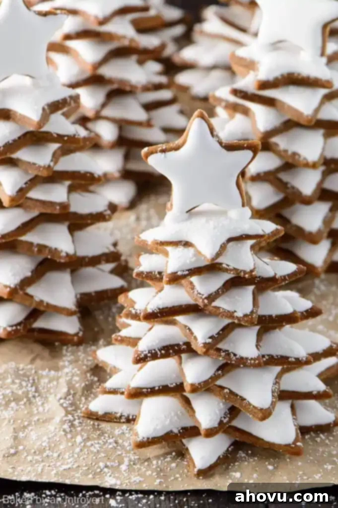 20+ Festive Christmas Cookie Ideas 17 Whimsical Snowy Gingerbread Christmas Trees, beautifully decorated.