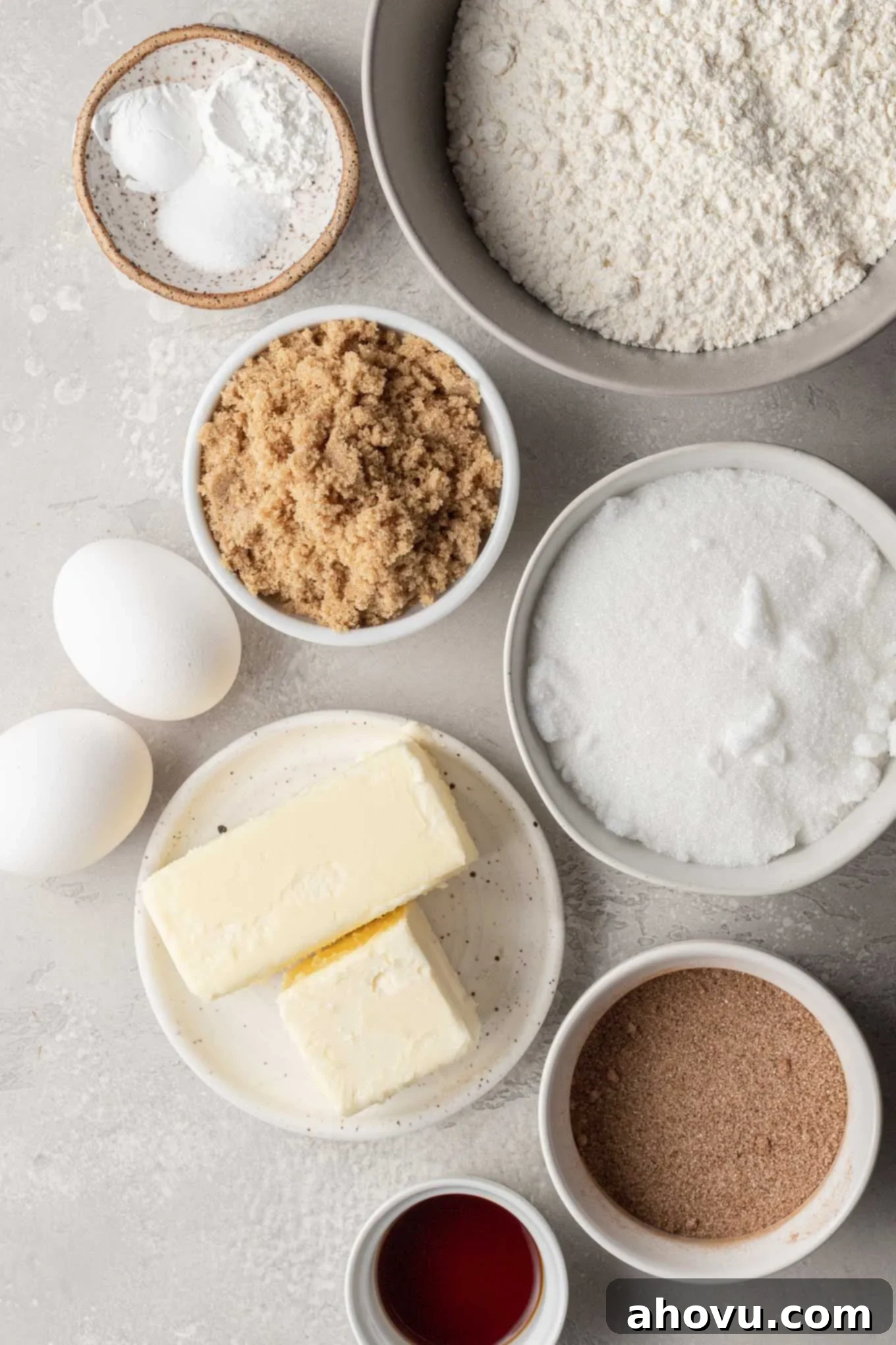An overhead view of all the essential ingredients neatly laid out on a kitchen counter, ready for making snickerdoodle blondies. Includes butter, sugars, eggs, flour, and spices.