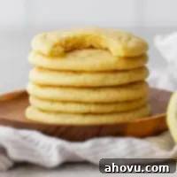 A stack of golden, soft lemon cookies, ready to be enjoyed.