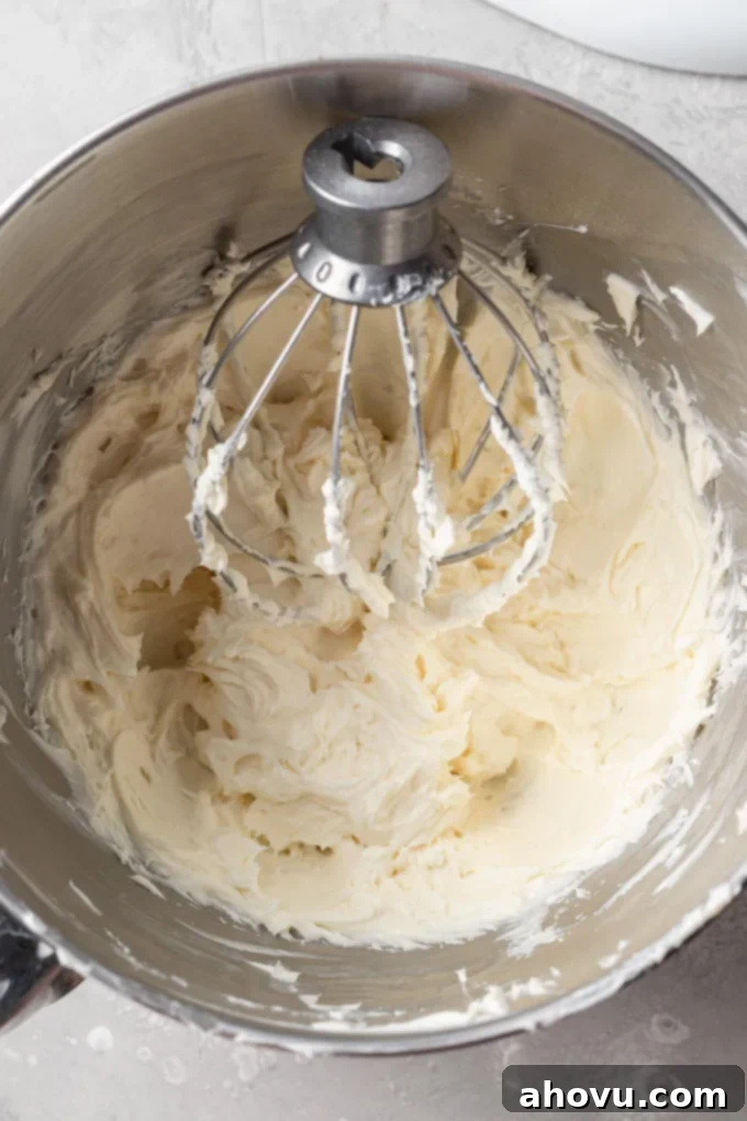 Decadent No-Bake Oreo Cheesecake 5 An overhead view of the smooth no-bake cheesecake filling being prepared in a mixing bowl.