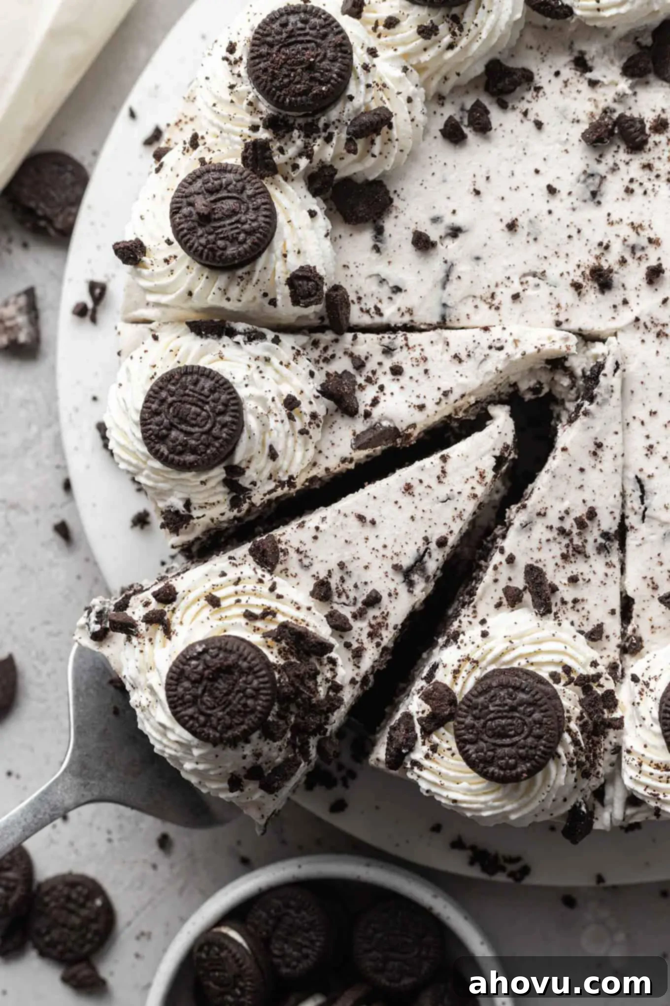 Decadent No-Bake Oreo Cheesecake 8 An overhead view of an Oreo cheesecake, with three perfect slices removed, showing its layers.