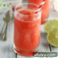 Watermelon Zest Cooler 6 A beautifully presented watermelon lime slushie in a glass, ready for enjoyment on a hot day.