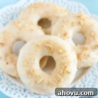 A delicious Key Lime Donut with glaze and graham cracker crumbles.