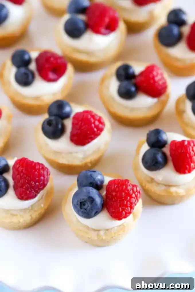 Zesty Berry Cheesecake Cookie Cups 2 Sugar cookie cups filled with a no-bake lemon cream cheese filling and topped with fresh berries. These Lemon Berry Cheesecake Sugar Cookie Cups make the perfect summer dessert!