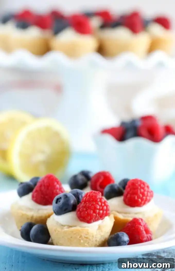 Zesty Berry Cheesecake Cookie Cups 3 Sugar cookie cups filled with a no-bake lemon cream cheese filling and topped with fresh berries. These Lemon Berry Cheesecake Sugar Cookie Cups make the perfect summer dessert!