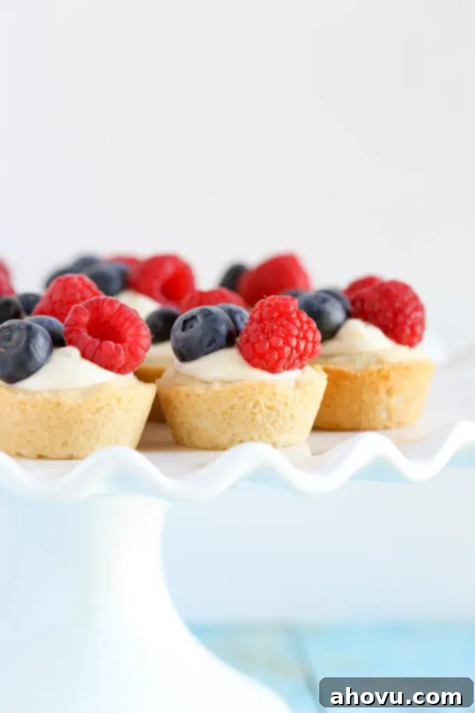 Zesty Berry Cheesecake Cookie Cups 4 Sugar cookie cups filled with a no-bake lemon cream cheese filling and topped with fresh berries. These Lemon Berry Cheesecake Sugar Cookie Cups make the perfect summer dessert!