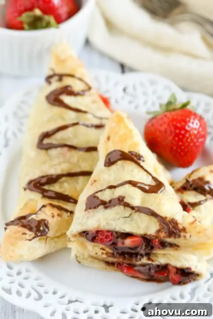Puff pastry stuffed with chocolate, Nutella, and fresh strawberries. These Chocolate Strawberry Nutella Turnovers make one delicious and decadent dessert!