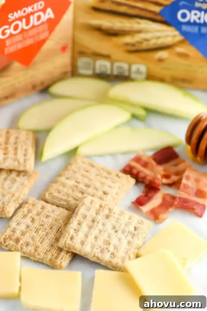 Honeyed Apple, Bacon & Smoked Gouda Bites 3 TRISCUIT Smoked Gouda Crackers adorned with fresh apple, crispy bacon, and a sweet honey drizzle.