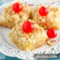 Delicious Coconut Pineapple Bars cut into squares, showcasing their golden-brown crumb topping and sweet, tangy filling.