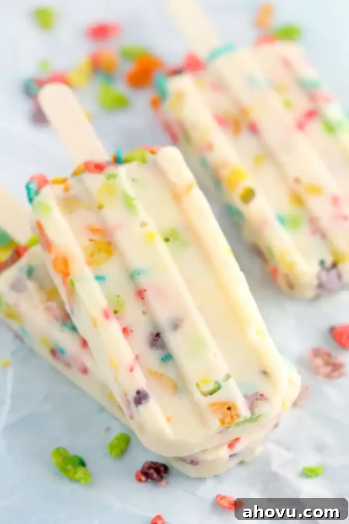 Brightly colored Marshmallow Fruity Pebbles cereal ready to be transformed into pudding pops.