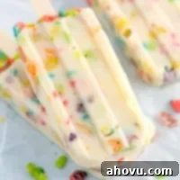 Marshmallow Fruity Pebbles Pudding Pops, showcasing the colorful cereal within the frozen treat.