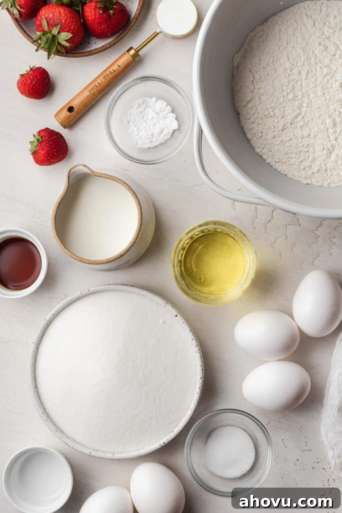 An inviting overhead view showcasing all the essential ingredients neatly arranged on a counter, ready for baking a delicious vanilla chiffon cake.