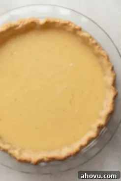 Unbaked buttermilk pie in a glass pie plate.