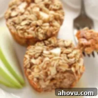A close-up of a baked apple cinnamon oatmeal cup, showcasing its golden-brown top and wholesome texture, ready for breakfast.