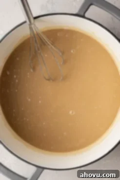 An overhead view of uncooked caramel in a saucepan.