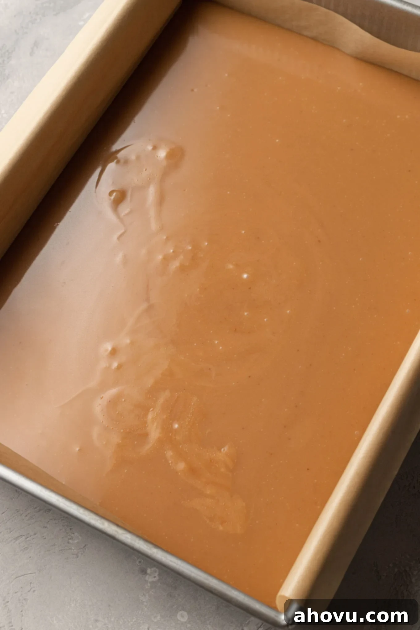 Warm caramel mixture cooling in a baking dish. 