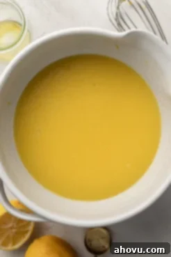 An overhead view of wet ingredients in a mixing bowl.