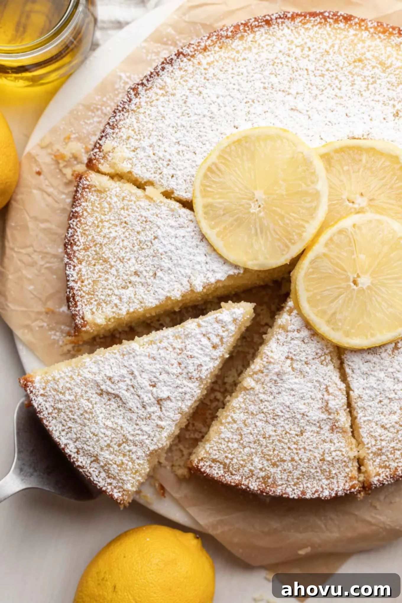 Sun-Kissed Lemon Olive Oil Cake 4 An overhead view of a sliced lemon olive oil cake.