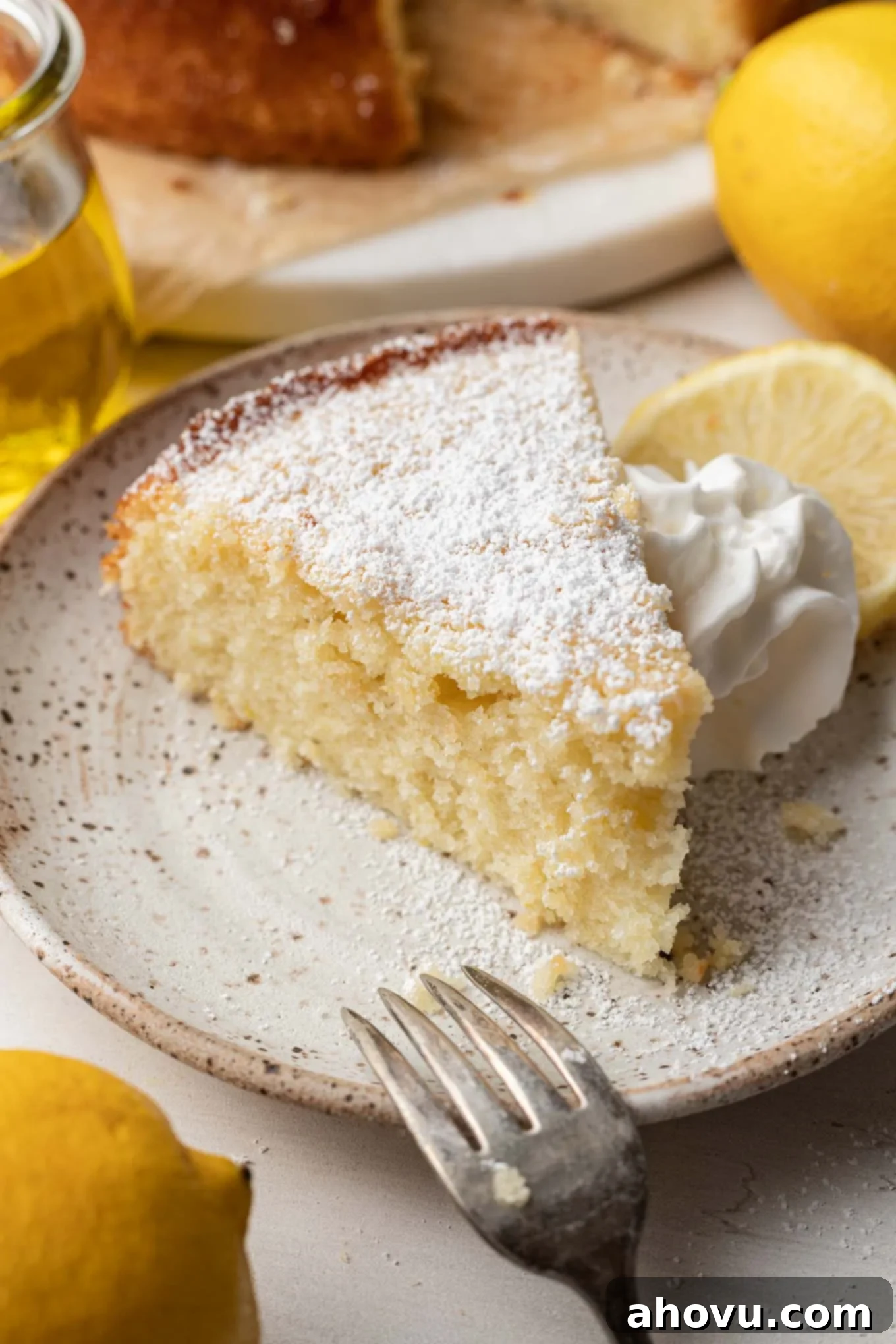 Sun-Kissed Lemon Olive Oil Cake 5 A slice of olive oil cake on a dessert plate.