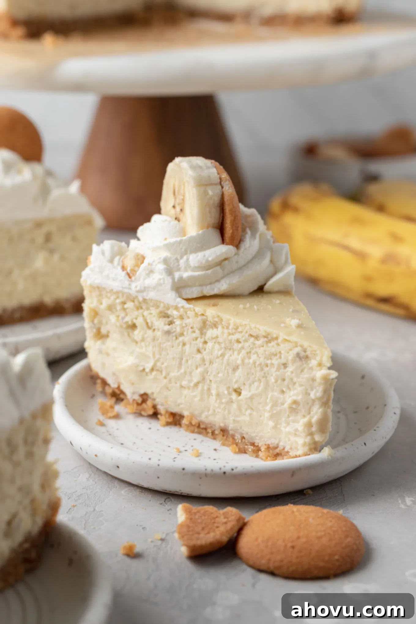 Banana Pudding Cheesecake 8 A slice of banana pudding cheesecake on a white plate.