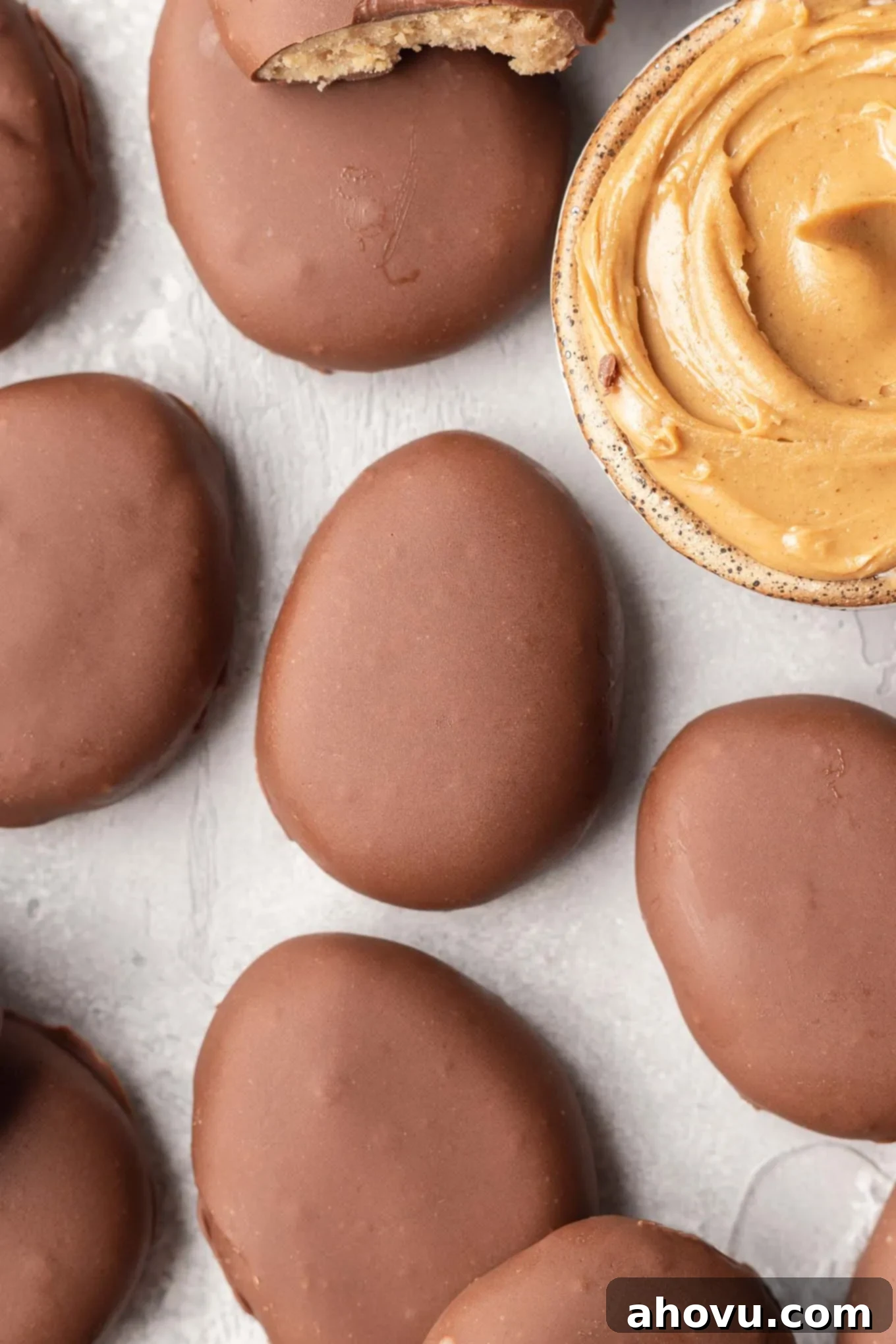 An overhead view of peanut butter Easter eggs with a dish of peanut butter. 