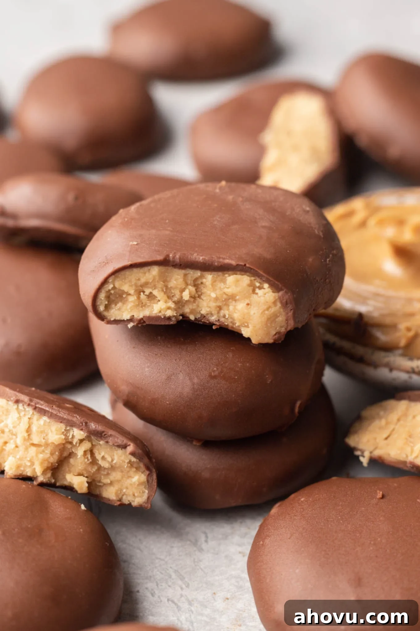 A close-up view of chocolate peanut butter eggs on parchment paper. 