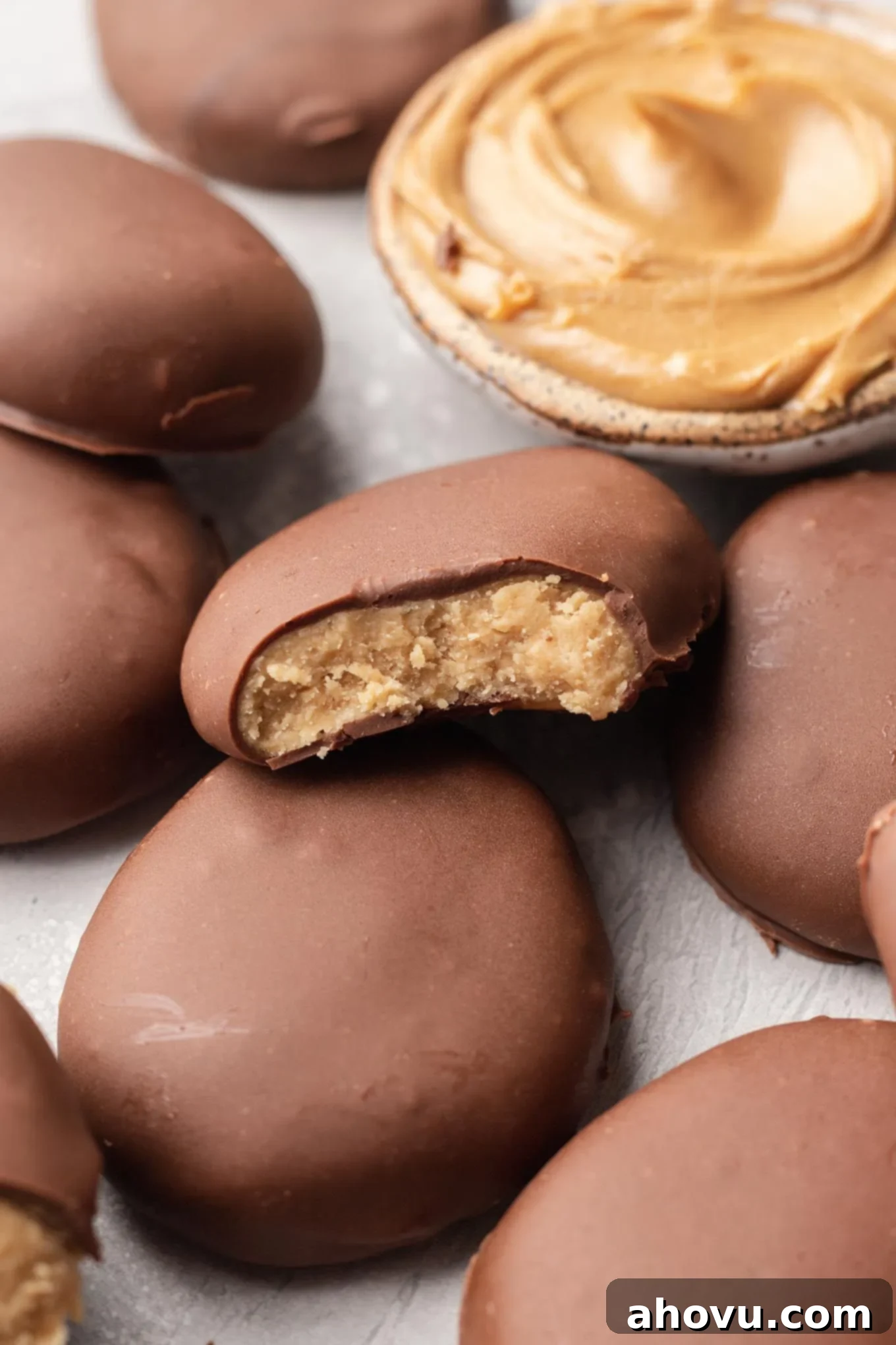 A peanut butter Easter egg with a bite missing, turned on its side to show the filling. 