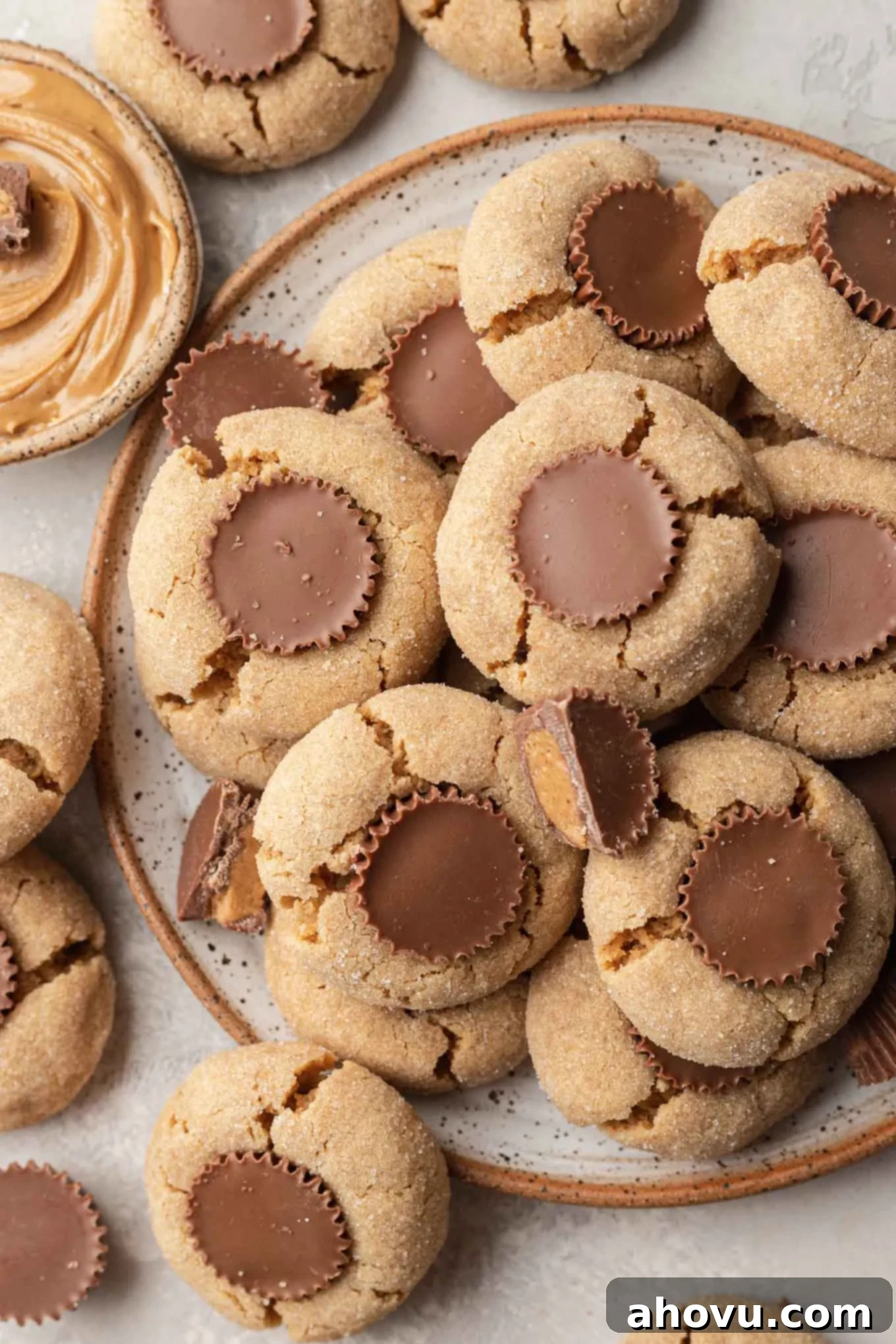 A delicious plate of freshly baked peanut butter cup cookies, garnished with mini Reese's.