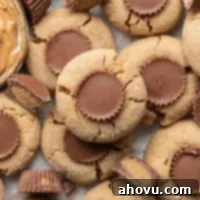 Several peanut butter cup cookies on a piece of parchment paper.