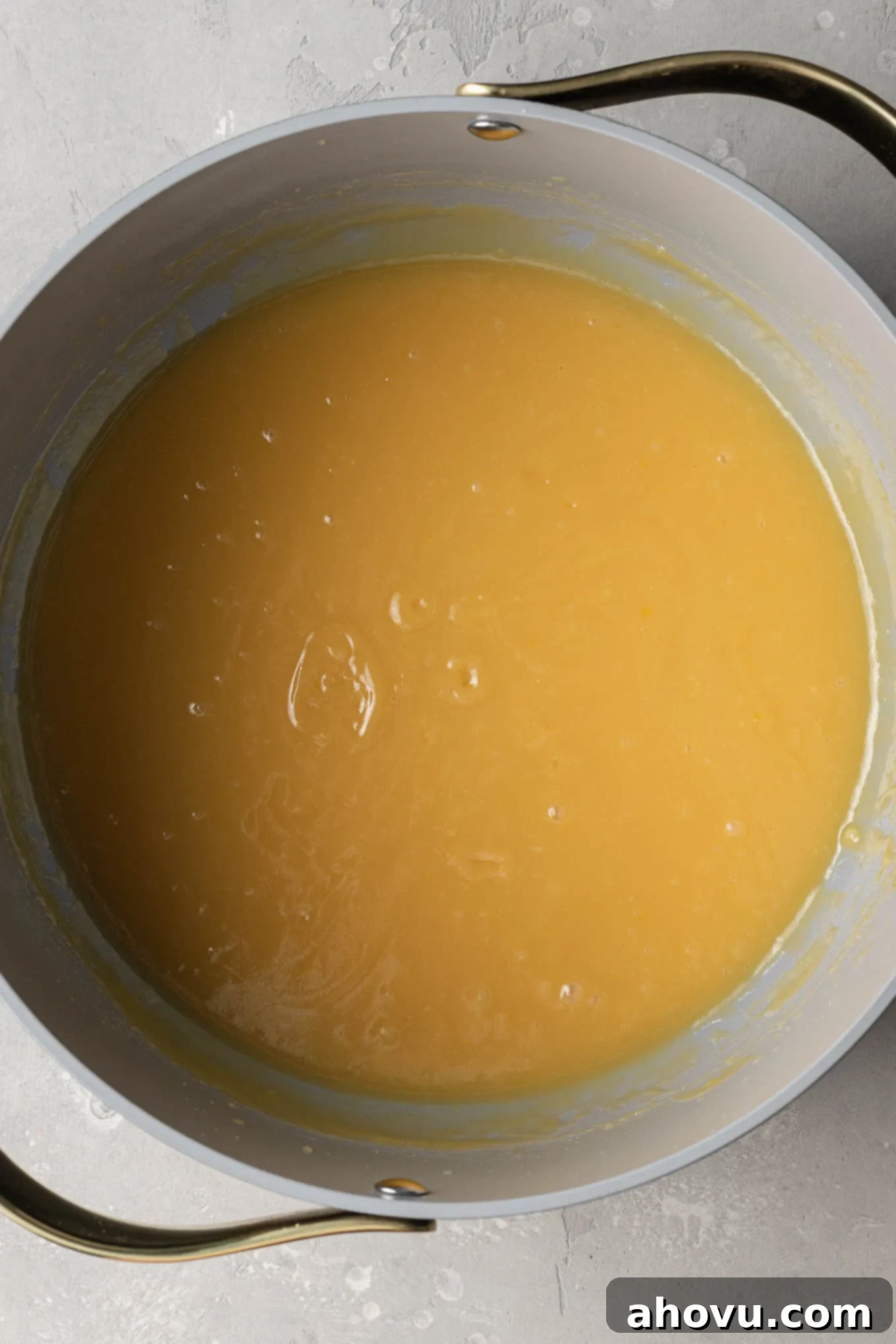 An overhead view of the base mixture for German chocolate cake frosting after it has been cooked, showing its thickened, light caramel color.